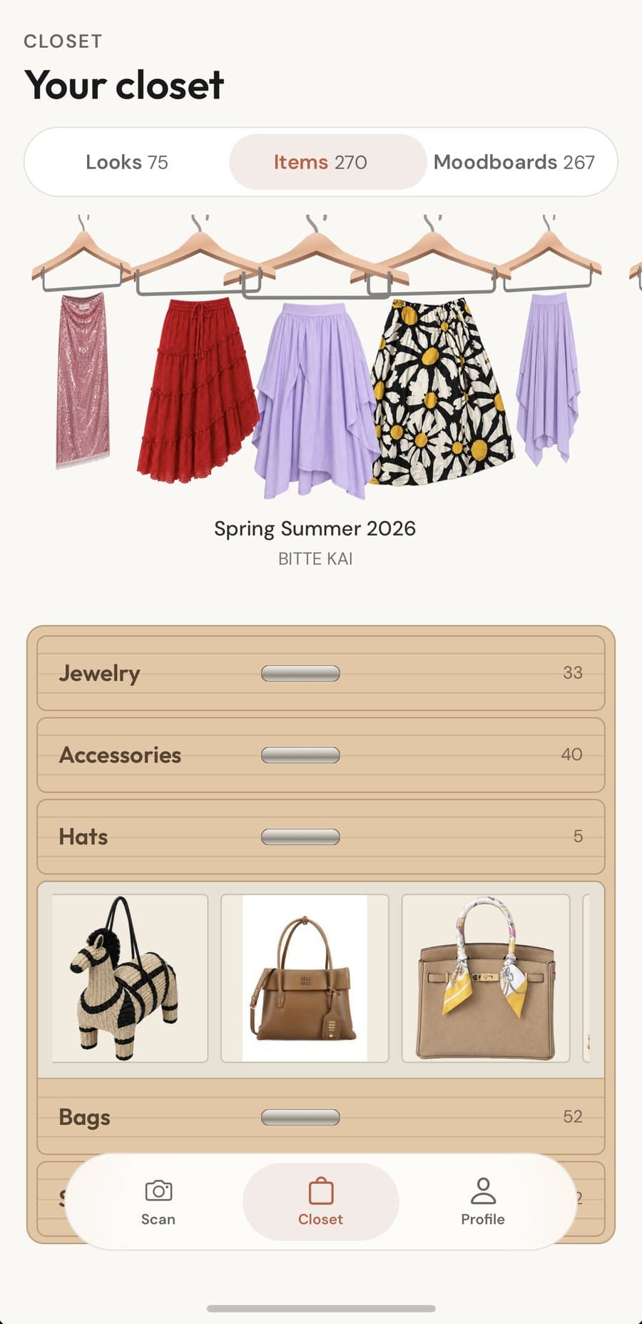 Skirts on a rail above the open bags drawer: a raffia zebra bag, a leather tote, a scarf-wrapped handbag